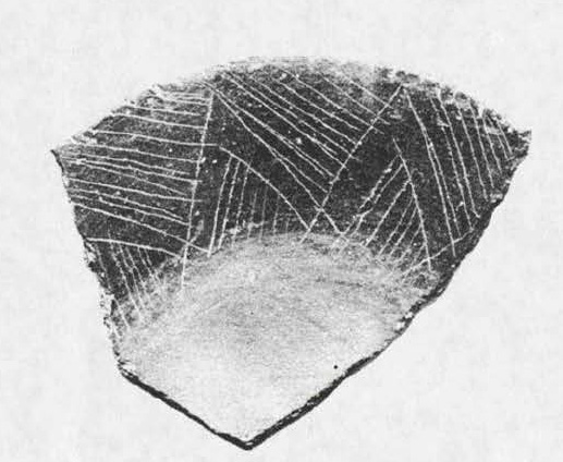 An interior-engraved, well-fired shallow bowl with outslanting sides.