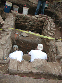 Archaeologists continue to excavate the privy.