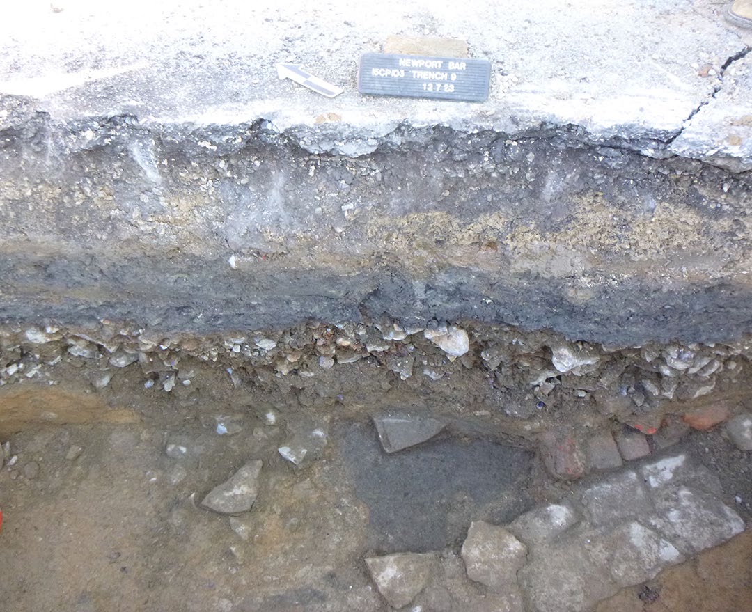 Profile of Backhoe Trench 9: a stone foundation covered with demolition debris and flood deposits.