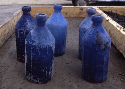 Blue glass bottles recovered from the site.
