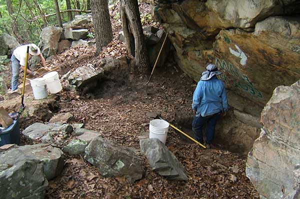 Archaeologists examine site.