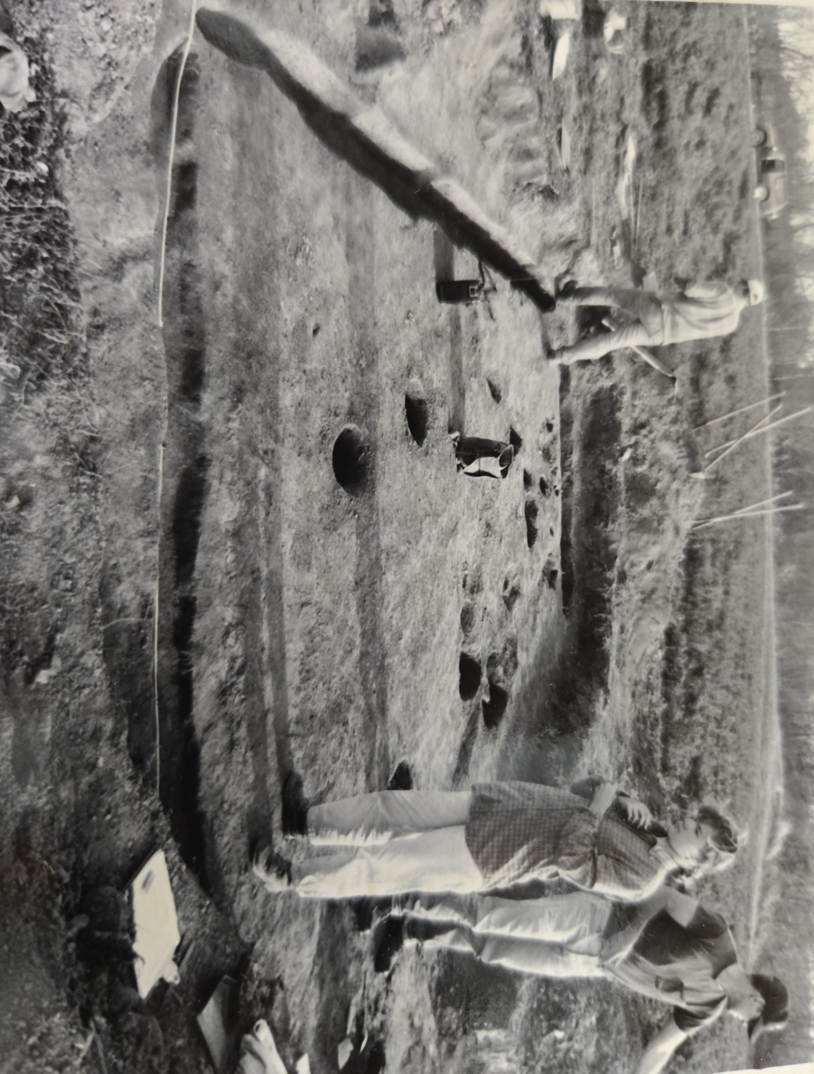 Archaeologists documenting the wall-trench house.
