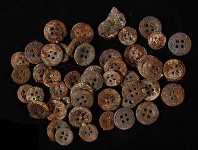 Burned caset-iron buttons from cellar.