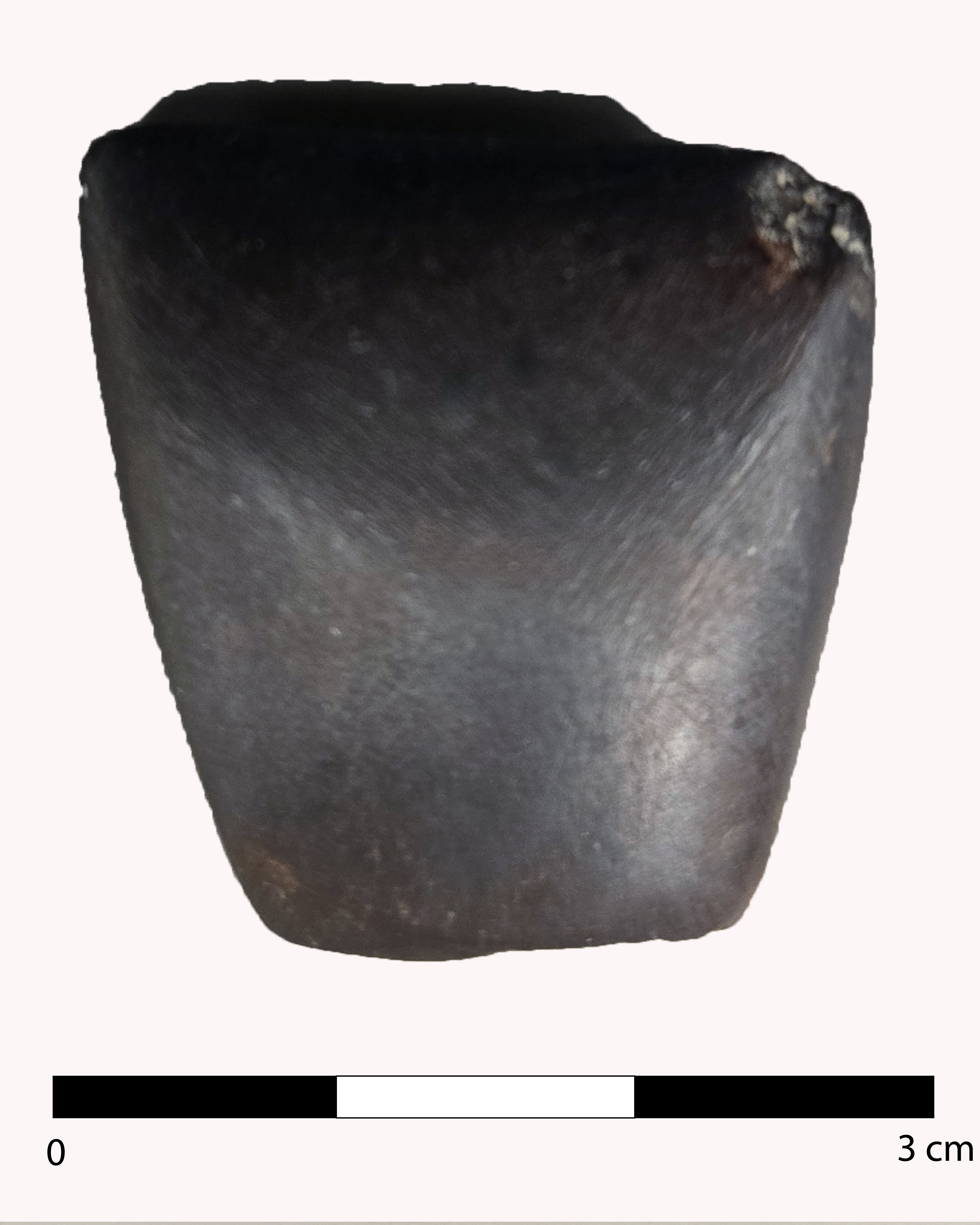 A miniature hematite celt.