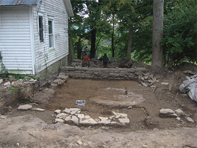 Kitchen/slave house foundation, with a fireplace (in the foreground).