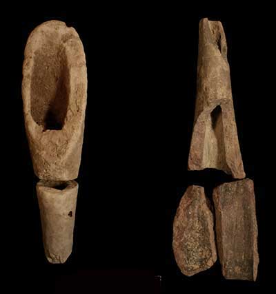 Intentionally broken (now mended) siltstone smoking pipe (left) and fine-grained sandstone pipe stem (right).