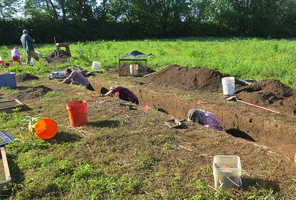 Archaeologists excavate trench at the Singer site