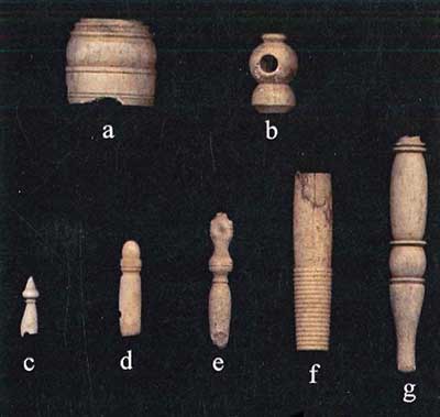 Bone objects: a, umbrella part; b, thimble case; c, d, e, knitting needle guards or ends; f, needle case; g, embroidery tool.