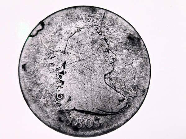 An 1807 "draped bust" of Lady Liberty silver half dollar.