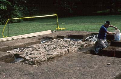 Excavation of the stone hearth and chimney foundation of the slave house.