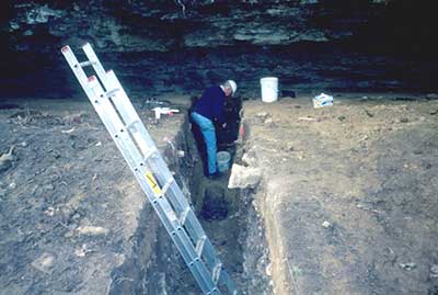 Archaeologists document the Miles Rockshelter site.