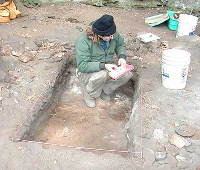 An archaeologist excavating a unit.