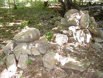 One of several stone burial mounds below the blufftop village.