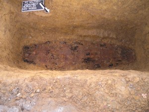 Green's coffin was packed with charcoal, seen here as dark patches in the dirt.