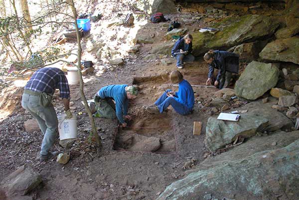 Archaeologists investigate the Twin Branch Rockshelter.