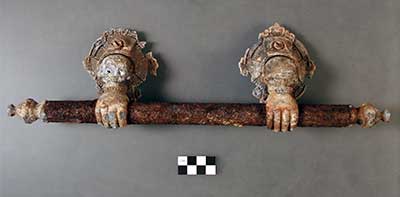 One of six decorative metal handles shaped to look like hands holding metal bars. 