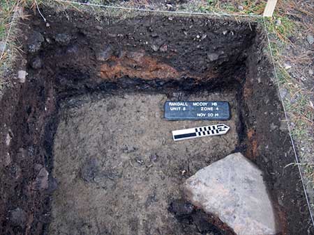 Many layers of fill covered a lower dark soil layer, which contained the remains of charred logs from the McCoy House.