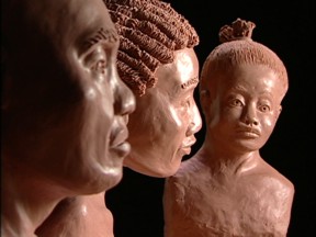 Individuals of African heritage: from left to right - older man, young woman, and infant.
