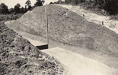 Trench through the enclosure's west wall:  Note the dark line of soil - the original ground surface.
