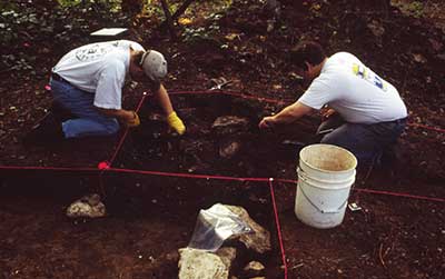 Archaeologists expose part of a cabin foundation at Site 15Es90.