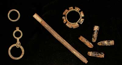 Personal objects:  watch chain part (left) and parasol or umbrella parts (right).